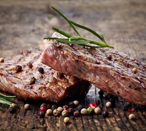 grilled beef steak on wooden cutting board